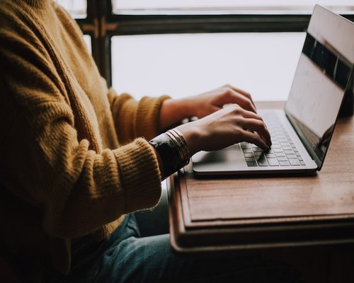 A person taking a short break from laptop screen working remotely